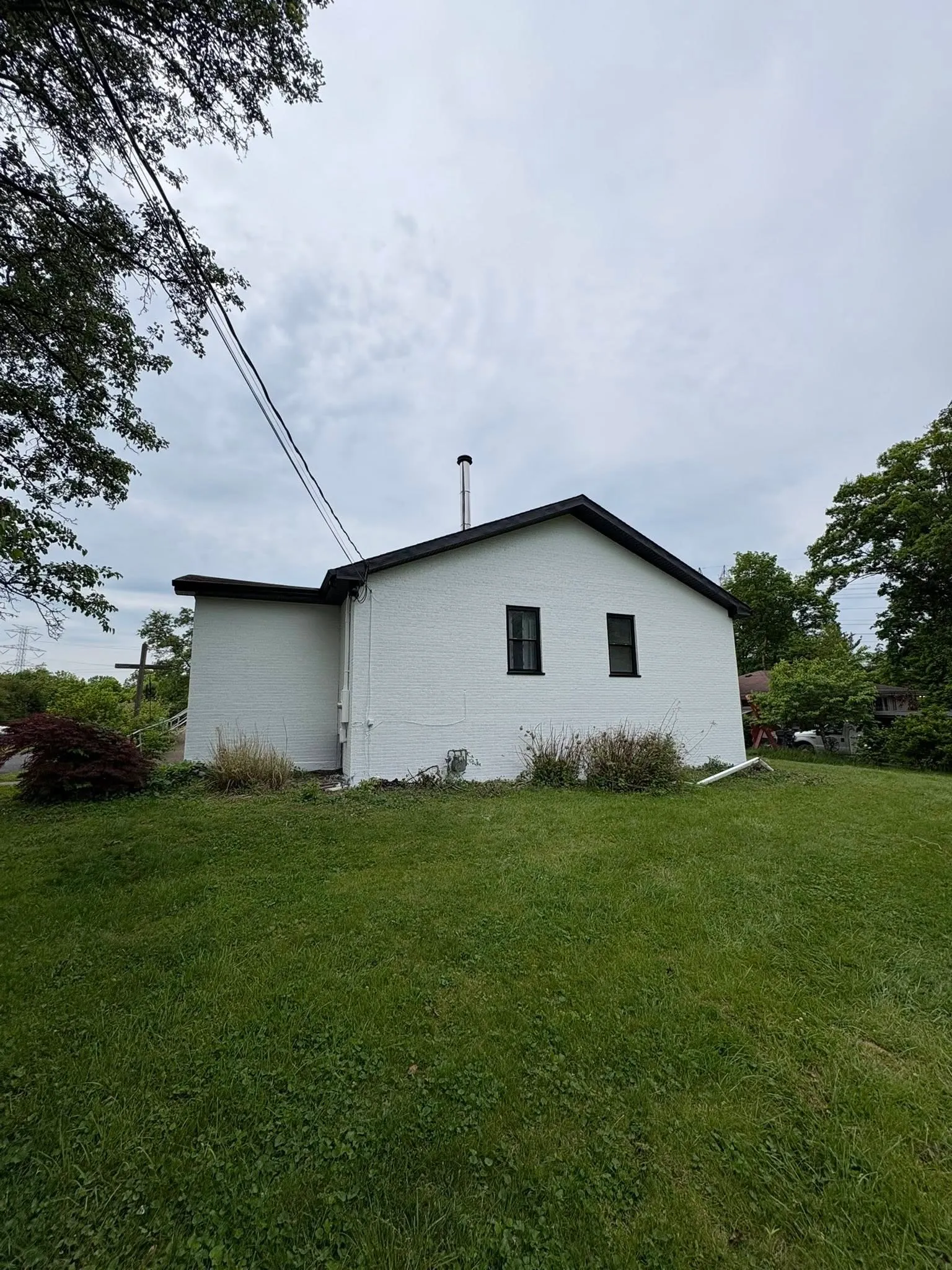 Large white-painted exterior of a church after professional repainting